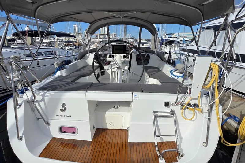 Slide: The Image of 2013 Beneteau Oceanis 37 sailboat cockpit with steering wheel, docked at marina. - 27