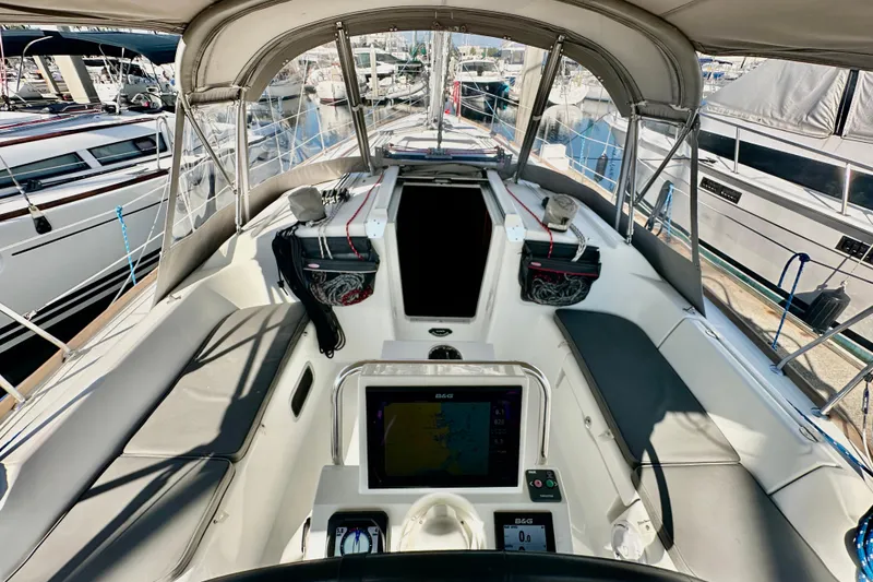 Slide: The Image of Cockpit view of 2013 Beneteau Oceanis 37 sailboat, featuring navigation equipment and seating. - 30