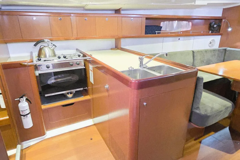Slide: The Image of Interior of 2013 Beneteau Oceanis 37 yacht with kitchen and seating area. - 5