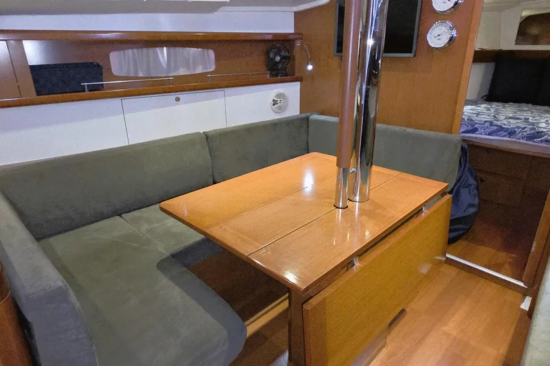 Slide: The Image of Interior of 2013 Beneteau Oceanis 37 sailboat with cozy seating and wooden table. - 6