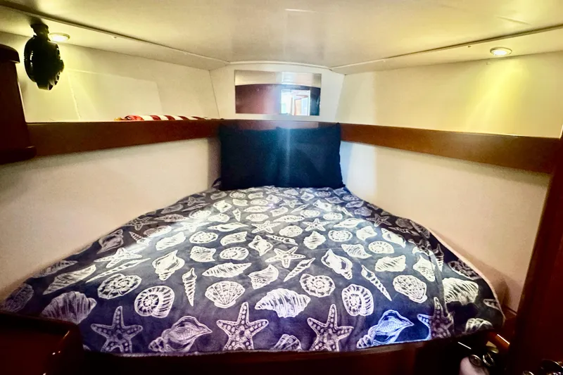 Slide: The Image of Cozy cabin interior of 2013 Beneteau Oceanis 37 with nautical-themed bedding. - 8