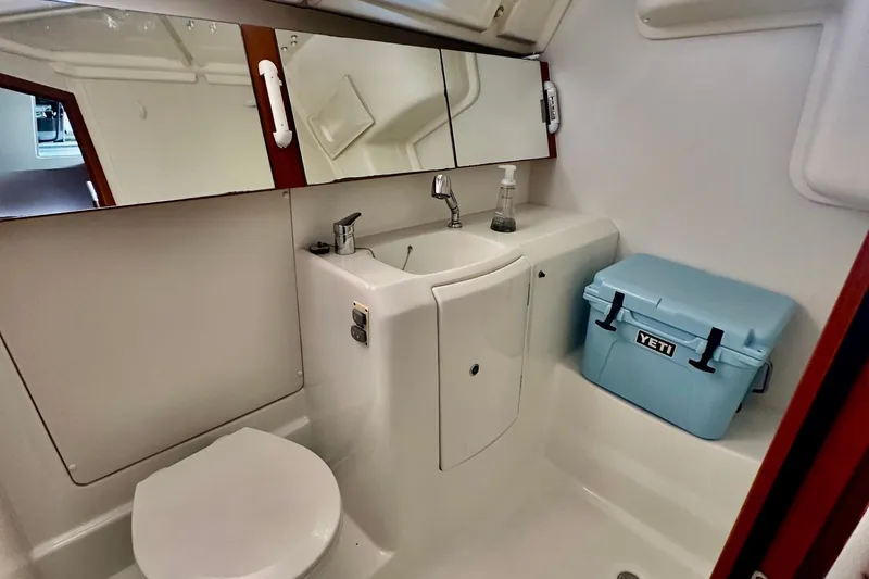 Slide: The Image of Bathroom of 2013 Beneteau Oceanis 37 yacht with sink, mirror, and Yeti cooler. - 9