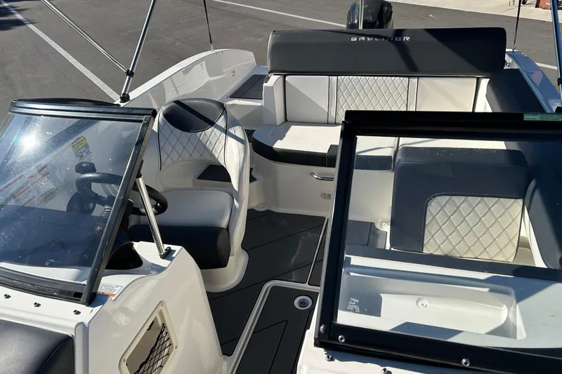 Slide: The Image of 2020 Bayliner DX 2000 boat interior with seating and steering wheel. - 10