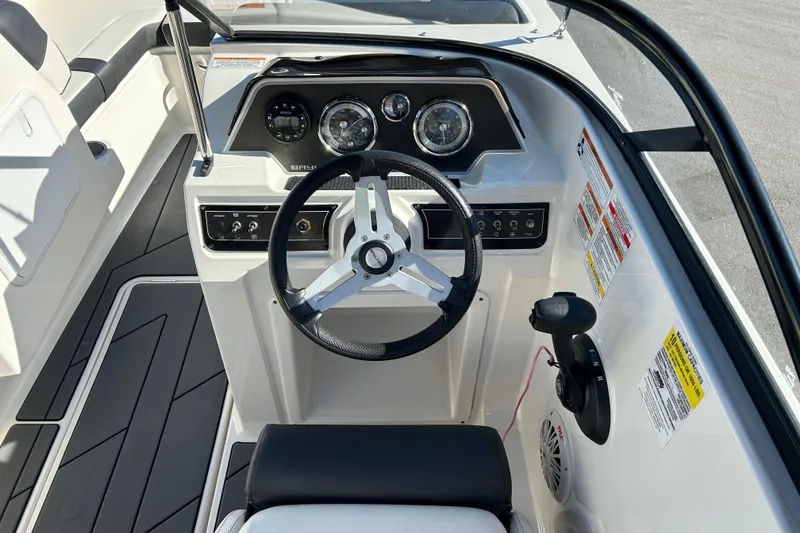Slide: The Image of 2020 Bayliner DX 2000 boat dashboard with steering wheel and control panel. - 11
