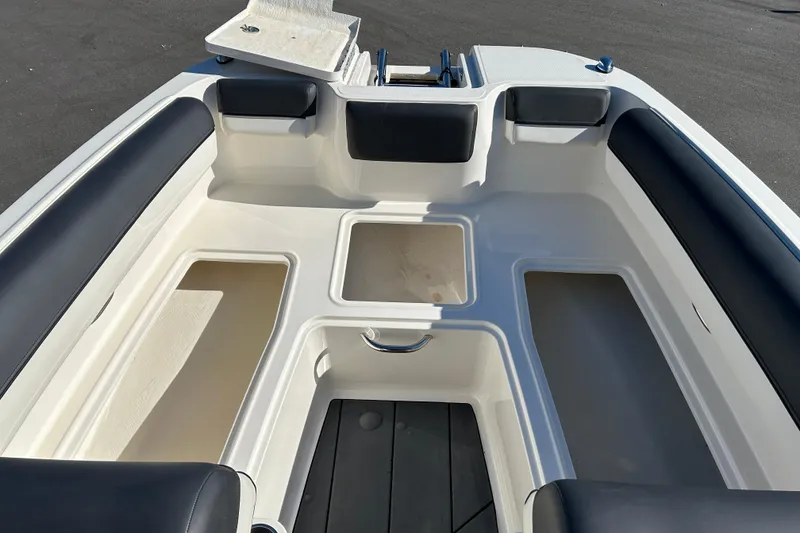 Slide: The Image of 2020 Bayliner DX 2000 boat interior with seating and storage compartments. - 15