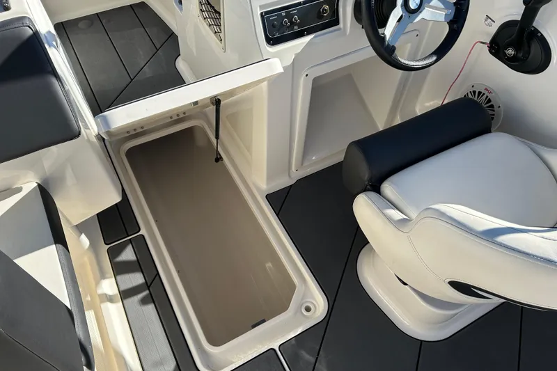 Slide: The Image of Interior of 2020 Bayliner DX 2000 boat showing storage compartment and seating. - 16