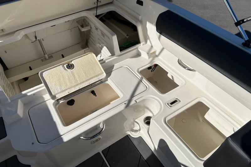 Slide: The Image of 2020 Bayliner DX 2000 boat interior with storage compartments and seating. - 17