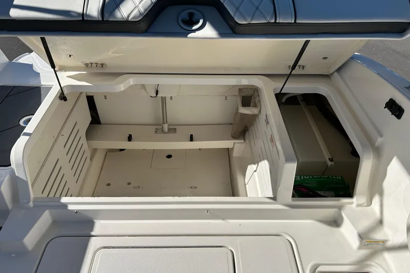 Slide: The Image of Open storage compartment of a 2020 Bayliner DX 2000 boat, showcasing interior space. - 18