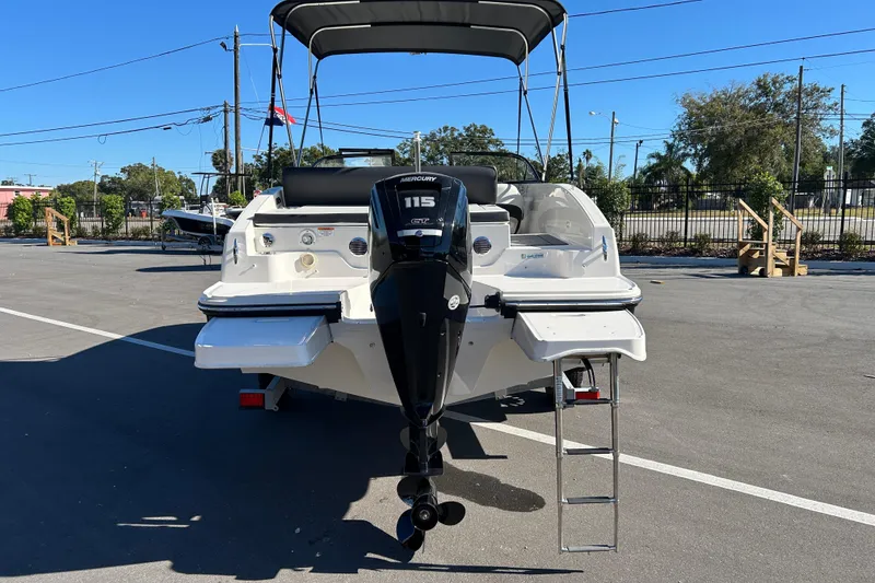 Slide: The Image of 2020 Bayliner DX 2000 boat with Mercury 115 engine, parked outdoors. - 3