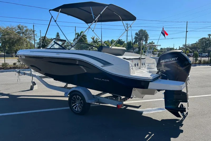 Slide: The Image of 2020 Bayliner DX 2000 boat with Mercury outboard motor on a trailer. - 4