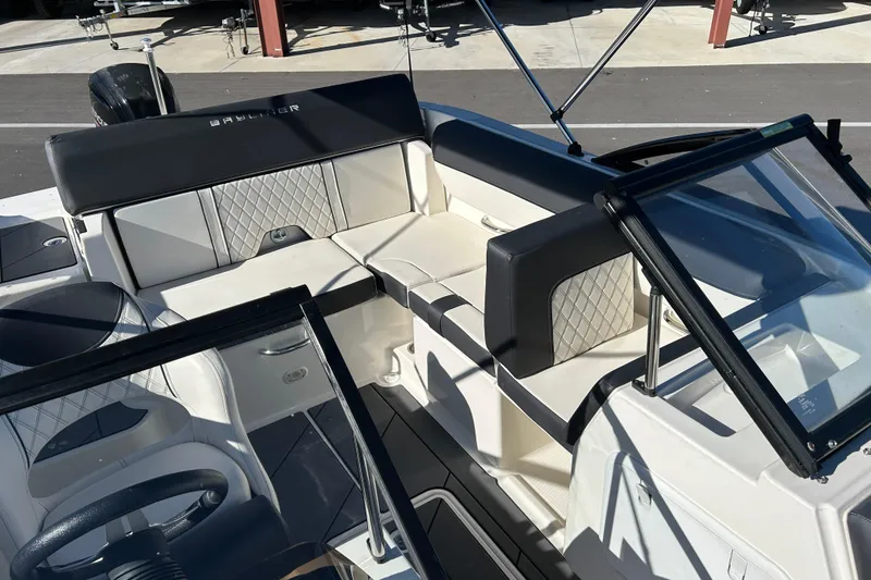 Slide: The Image of 2020 Bayliner DX 2000 boat interior with cushioned seating and windshield. - 9