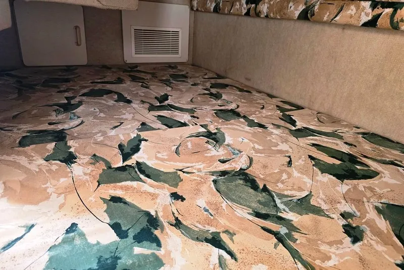 Slide: The Image of Interior of 1999 Sea Ray 270 Sundancer boat with portholes and showerhead. - 10