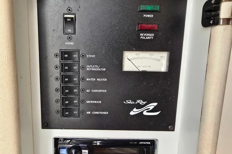 Slide: The Image of 1999 Sea Ray 270 Sundancer cabin interior with patterned upholstery and storage compartments. - 11