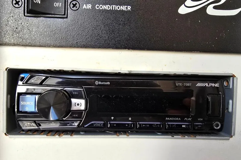 Slide: The Image of 1999 Sea Ray 270 Sundancer control panel with switches and voltage meter. - 12