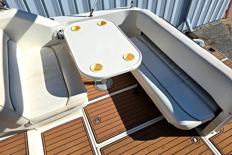 Slide: The Image of 1999 Sea Ray 270 Sundancer boat on trailer, parked near metal building. - 15