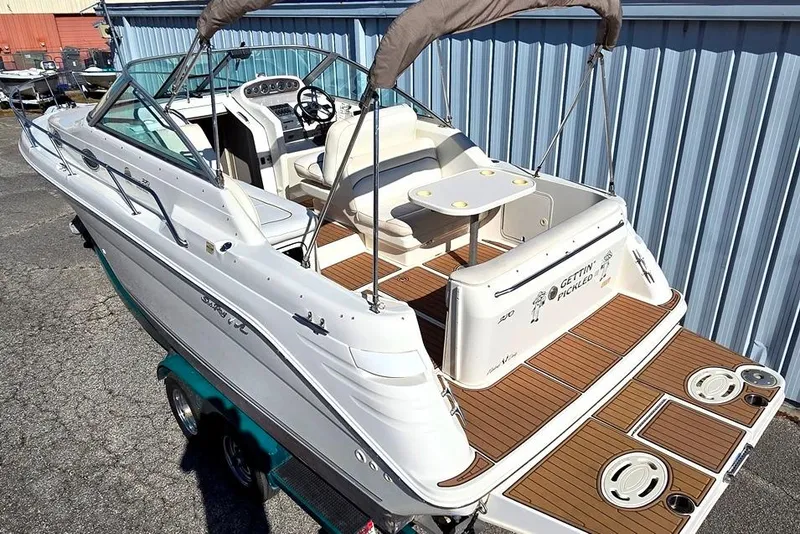 Slide: The Image of 1999 Sea Ray 270 Sundancer boat with spacious deck and seating area. - 2