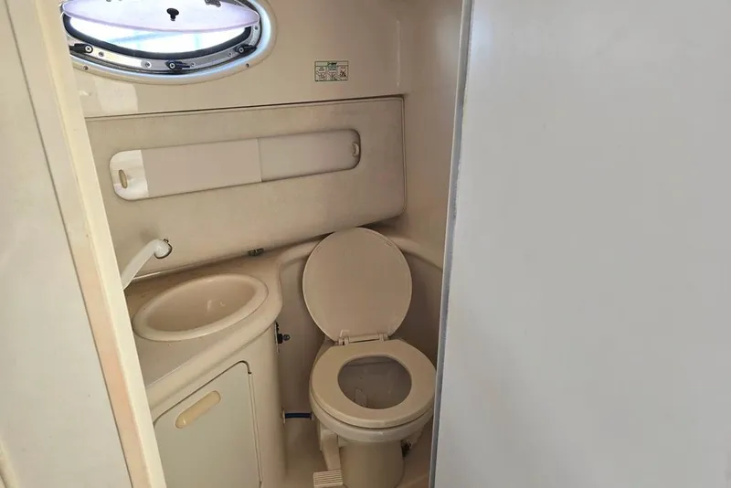 Slide: The Image of Interior of 1999 Sea Ray 270 Sundancer boat with kitchenette and seating area. - 8