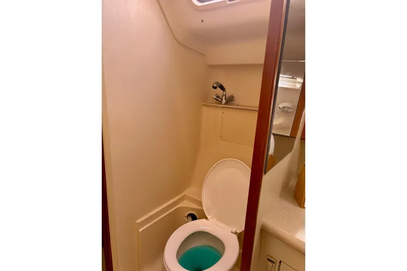 Slide: The Image of Compact bathroom in 2004 Hunter 386 sailboat with toilet and sink. - 11