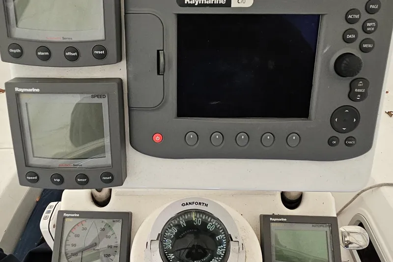 Slide: The Image of Control panel of a 2004 Hunter 386 sailboat with Raymarine navigation instruments. - 14