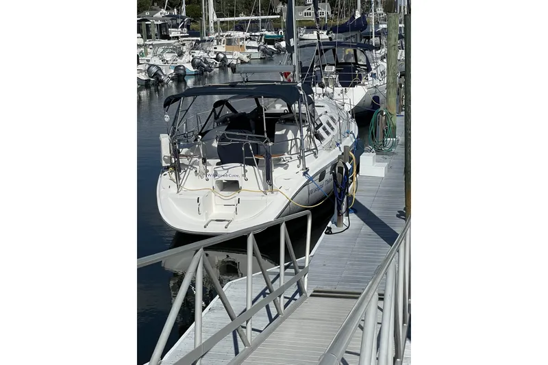 Slide: The Image of Hunter 386 sailboat, 2004 model, docked at a marina with other boats. - 3