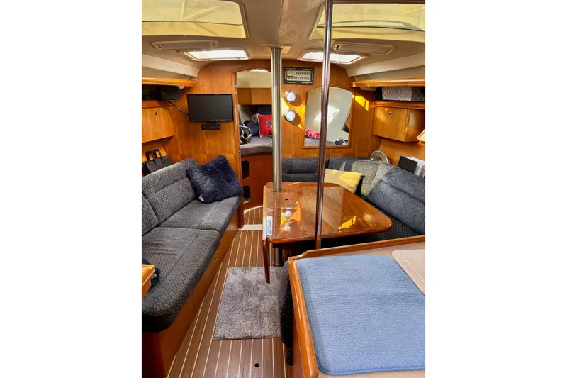 Slide: The Image of Interior of 2004 Hunter 386 sailboat with cozy seating and wooden finishes. - 4