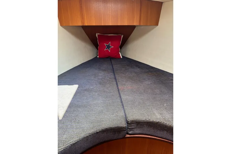 Slide: The Image of Cozy cabin interior of 2004 Hunter 386 sailboat with star-themed pillow. - 5