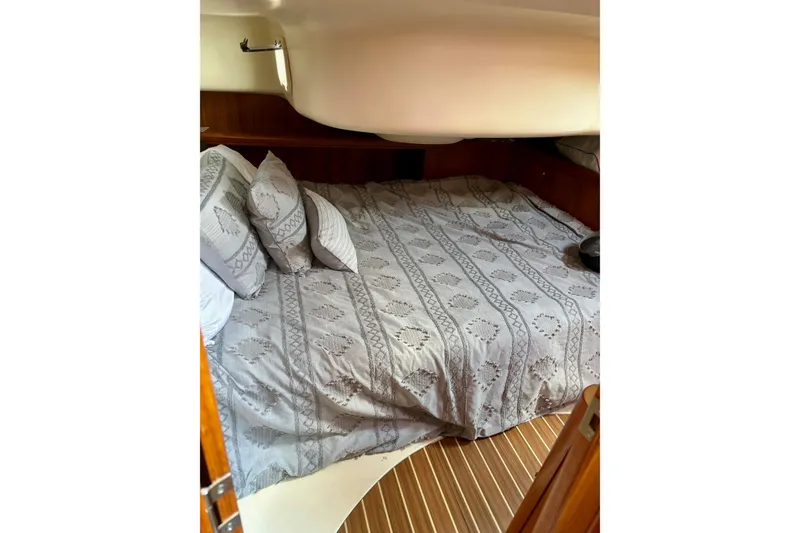 Slide: The Image of Cozy cabin interior of 2004 Hunter 386 sailboat with patterned bedding. - 9