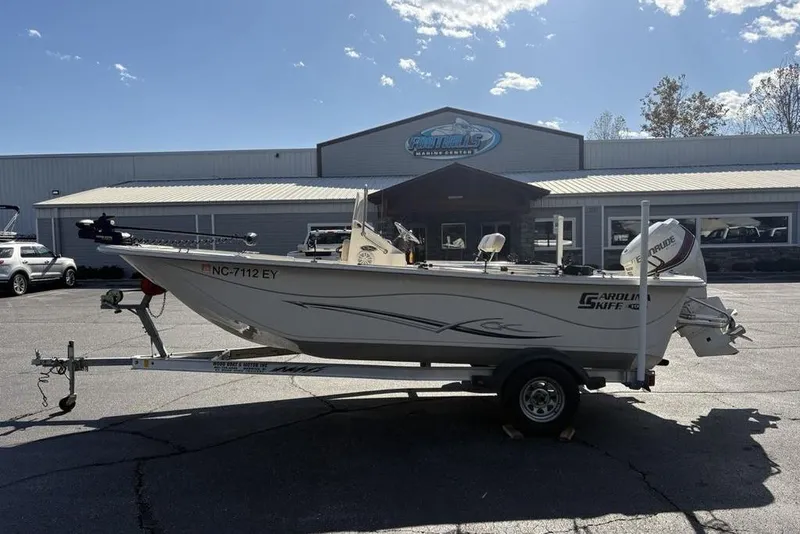 The Image of 2017 Carolina Skiff 198 DLV boat on trailer outside marine center. - 1