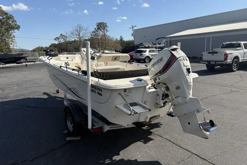 Slide: The Image of 2017 Carolina Skiff 198 DLV boat on trailer, parked outdoors. - 10