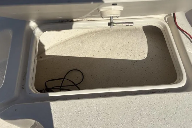 Slide: The Image of Open storage compartment on a 2017 Carolina Skiff 198 DLV boat. - 11