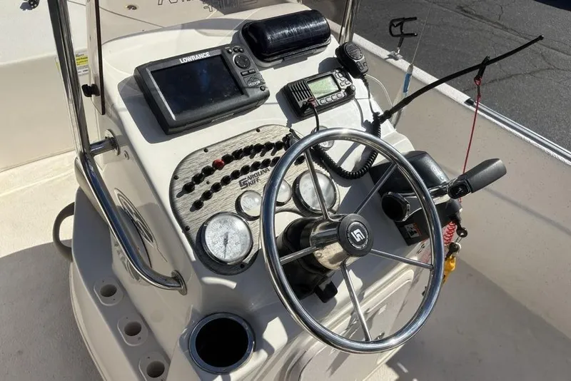 Slide: The Image of 2017 Carolina Skiff 198 DLV boat console with steering wheel and navigation equipment. - 17