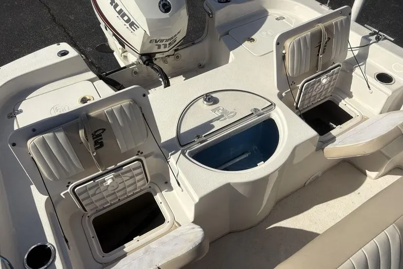Slide: The Image of 2017 Carolina Skiff 198 DLV boat interior with storage compartments and Evinrude motor. - 28
