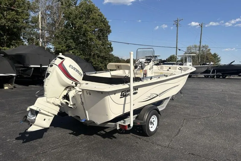 Slide: The Image of 2017 Carolina Skiff 198 DLV boat on trailer, featuring Evinrude outboard motor. - 3