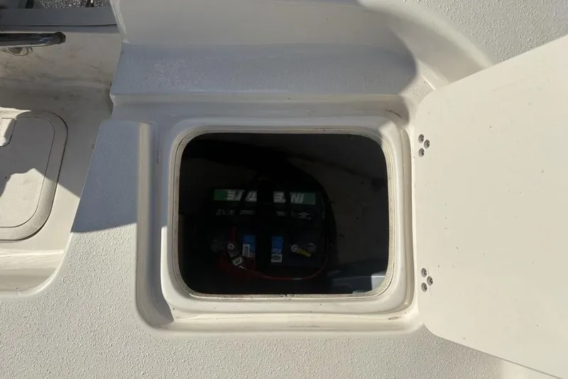 Slide: The Image of Battery compartment of a 2017 Carolina Skiff 198 DLV boat, open hatch view. - 34