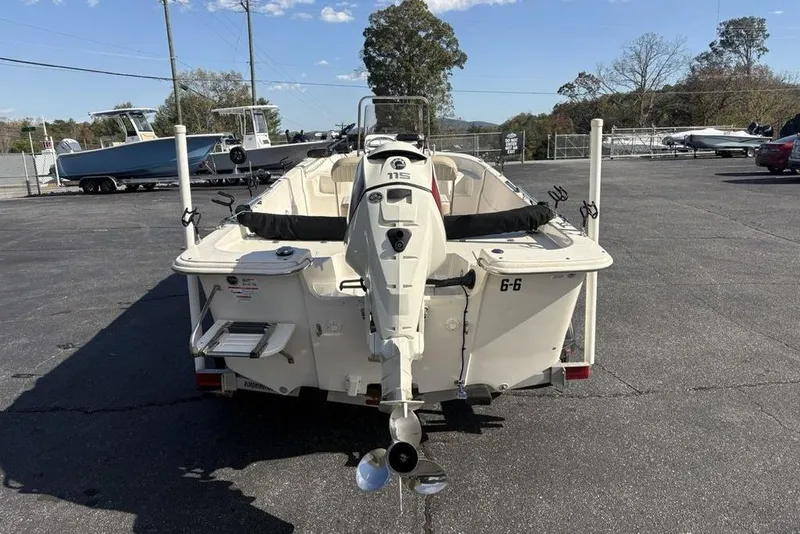 Slide: The Image of 2017 Carolina Skiff 198 DLV boat with outboard motor in a parking lot. - 5