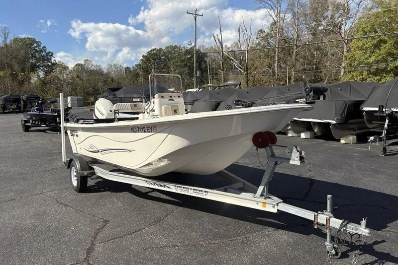 Slide: The Image of 2017 Carolina Skiff 198 DLV boat on trailer in parking lot. - 6