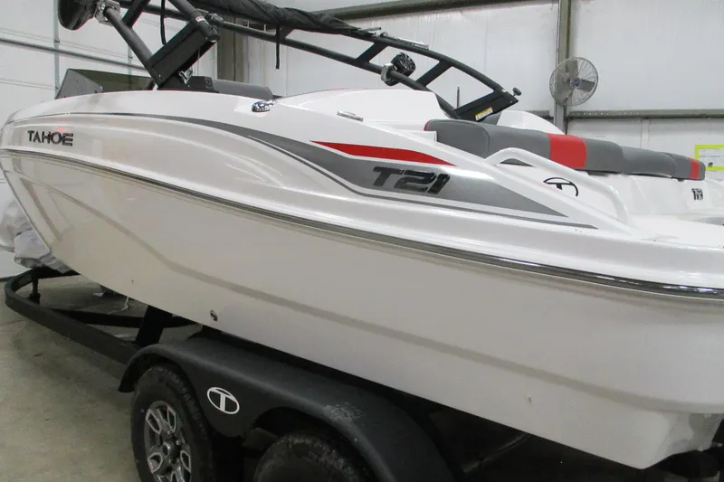 Slide: The Image of 2025 Tahoe T21 boat on trailer in indoor storage facility. - 0