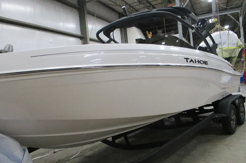 Slide: The Image of 2025 Tahoe T21 boat on trailer in indoor storage facility. - 1