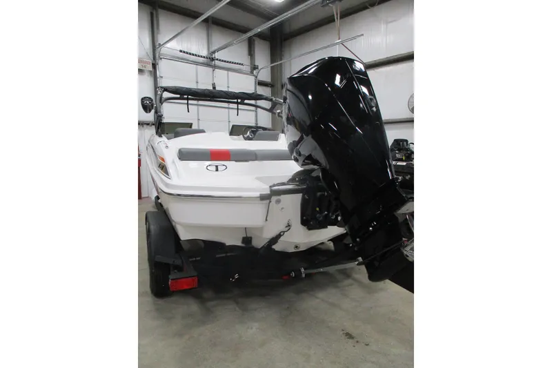 Slide: The Image of 2025 Tahoe T21 boat with outboard motor in a garage setting. - 4