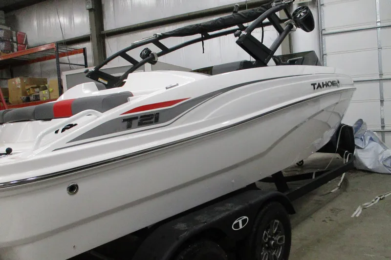 Slide: The Image of 2025 Tahoe T21 boat in a garage, featuring sleek white design and modern detailing. - 7
