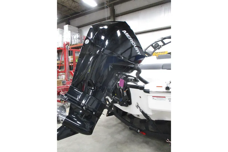 Slide: The Image of Outboard motor on a 2025 Tahoe T21 boat in a warehouse setting. - 8