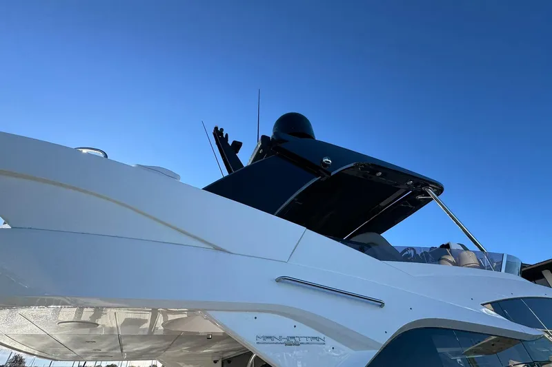 Slide: The Image of 2022 Sunseeker Manhattan 55 yacht against clear blue sky. - 11