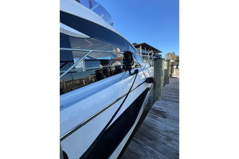 Slide: The Image of 2022 Sunseeker Manhattan 55 yacht docked at a marina, side view. - 12