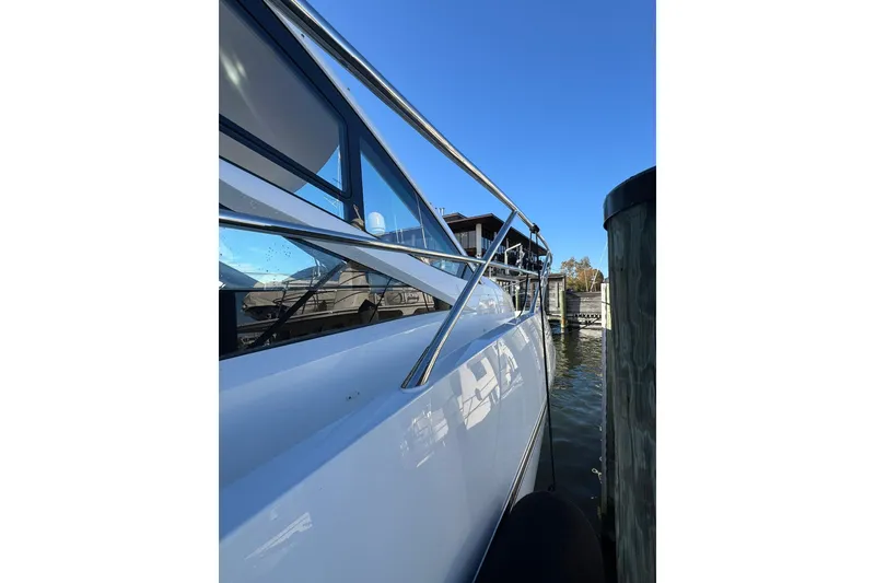 Slide: The Image of 2022 Sunseeker Manhattan 55 yacht docked, showcasing sleek design and modern features. - 13