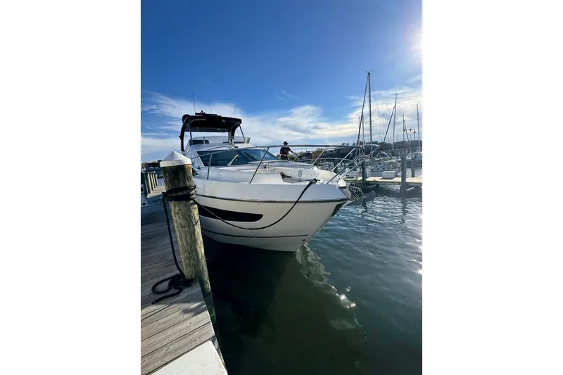 Slide: The Image of 2022 Sunseeker Manhattan 55 yacht docked at marina under clear blue sky. - 14