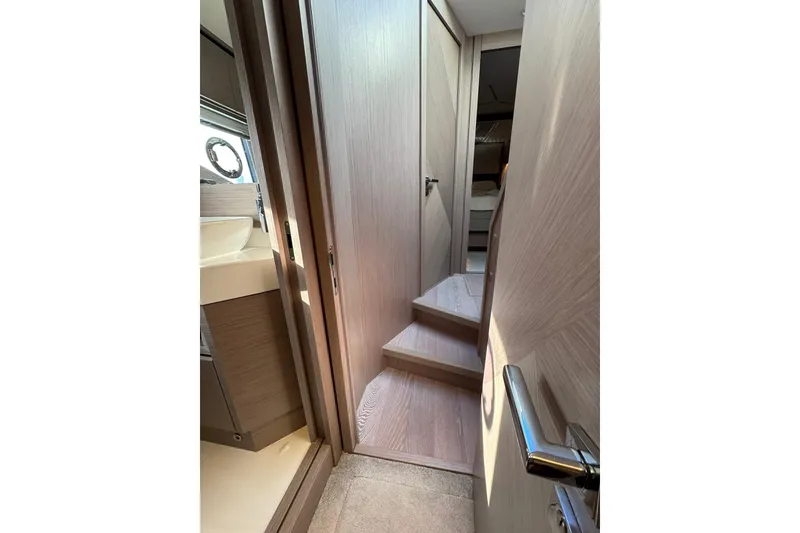 Slide: The Image of Interior hallway of 2022 Sunseeker Manhattan 55 yacht with wooden steps and modern design. - 19