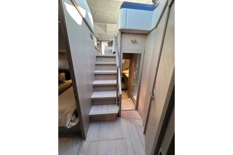 Slide: The Image of Interior of 2022 Sunseeker Manhattan 55 yacht, featuring modern wooden staircase and elegant design. - 20