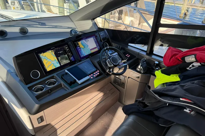 Slide: The Image of Cockpit of 2022 Sunseeker Manhattan 55 yacht with navigation screens and controls. - 21