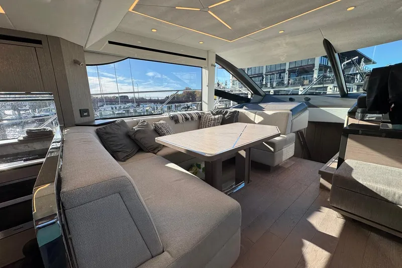 Slide: The Image of Luxurious interior of 2022 Sunseeker Manhattan 55 yacht with elegant seating and panoramic windows. - 22