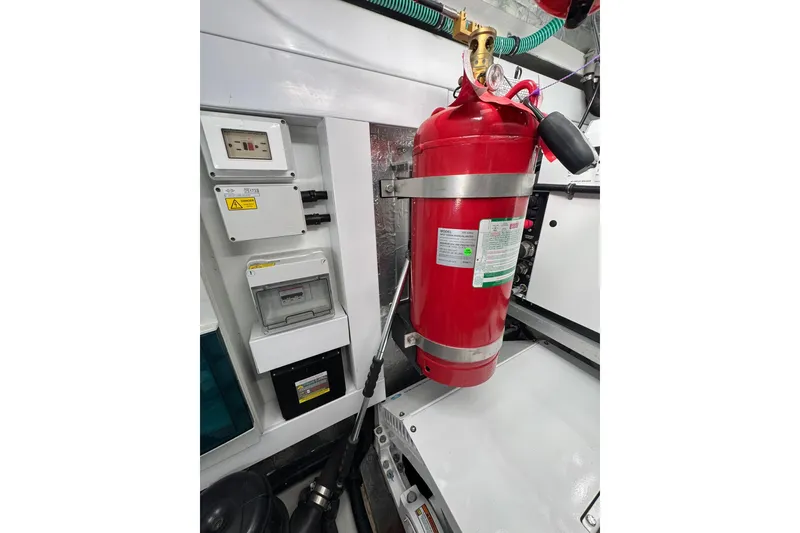 Slide: The Image of Engine room of 2022 Sunseeker Manhattan 55 with fire extinguisher and control panels. - 27